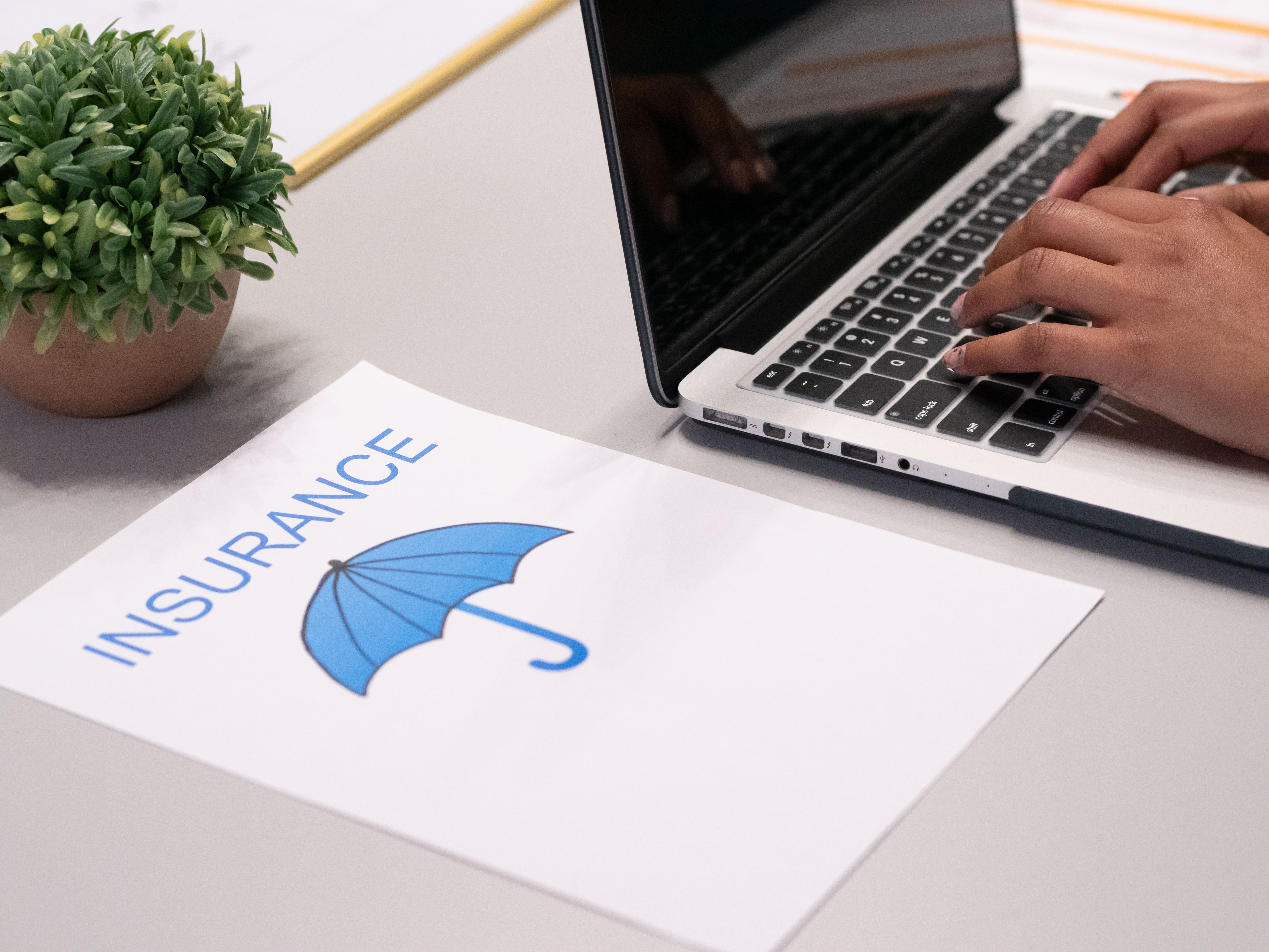 laptop showing insurance rate comparisons and digital documents - compare insurance quotes