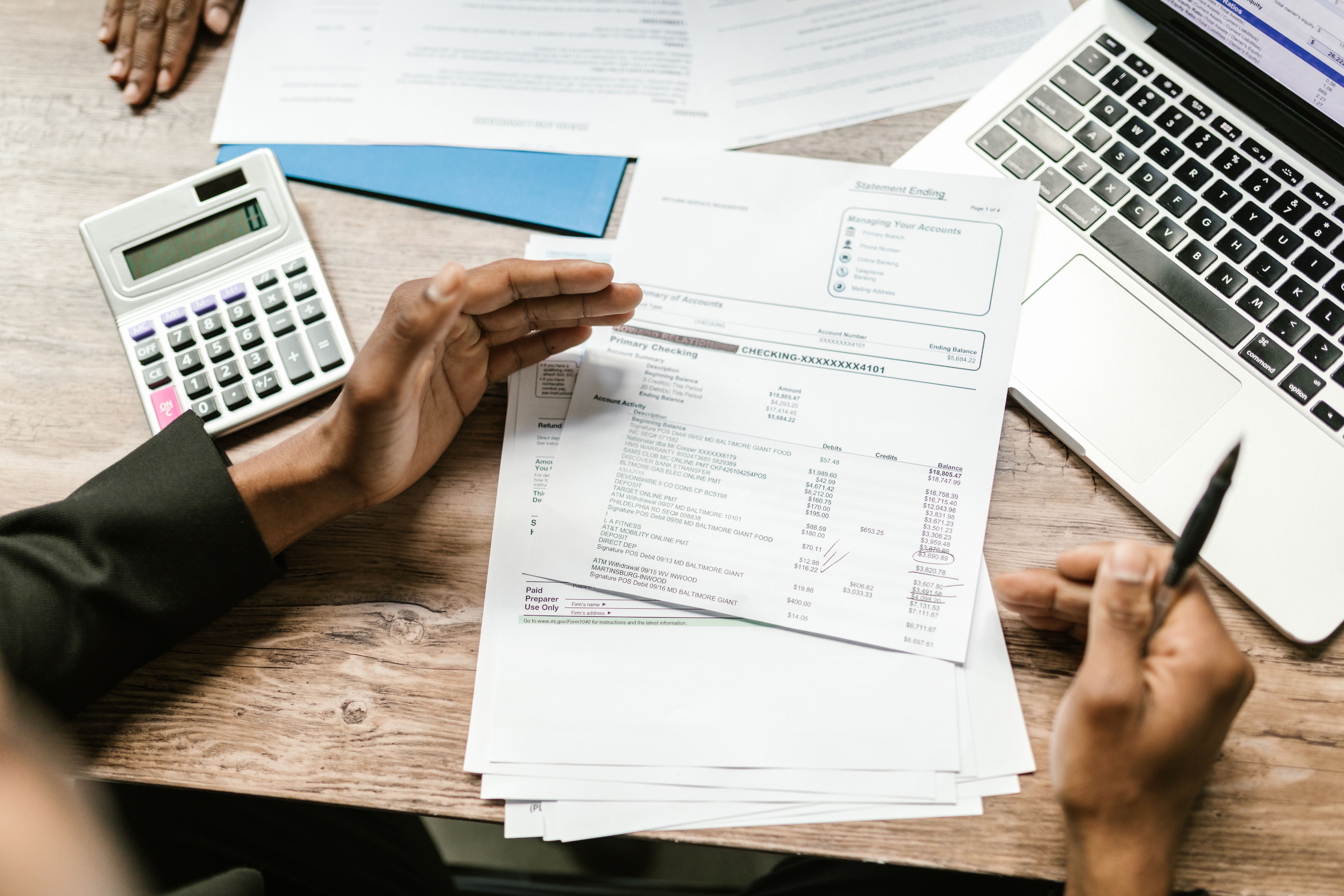 Person reviewing a financial statement and insurance policy - renters insurance cost per year