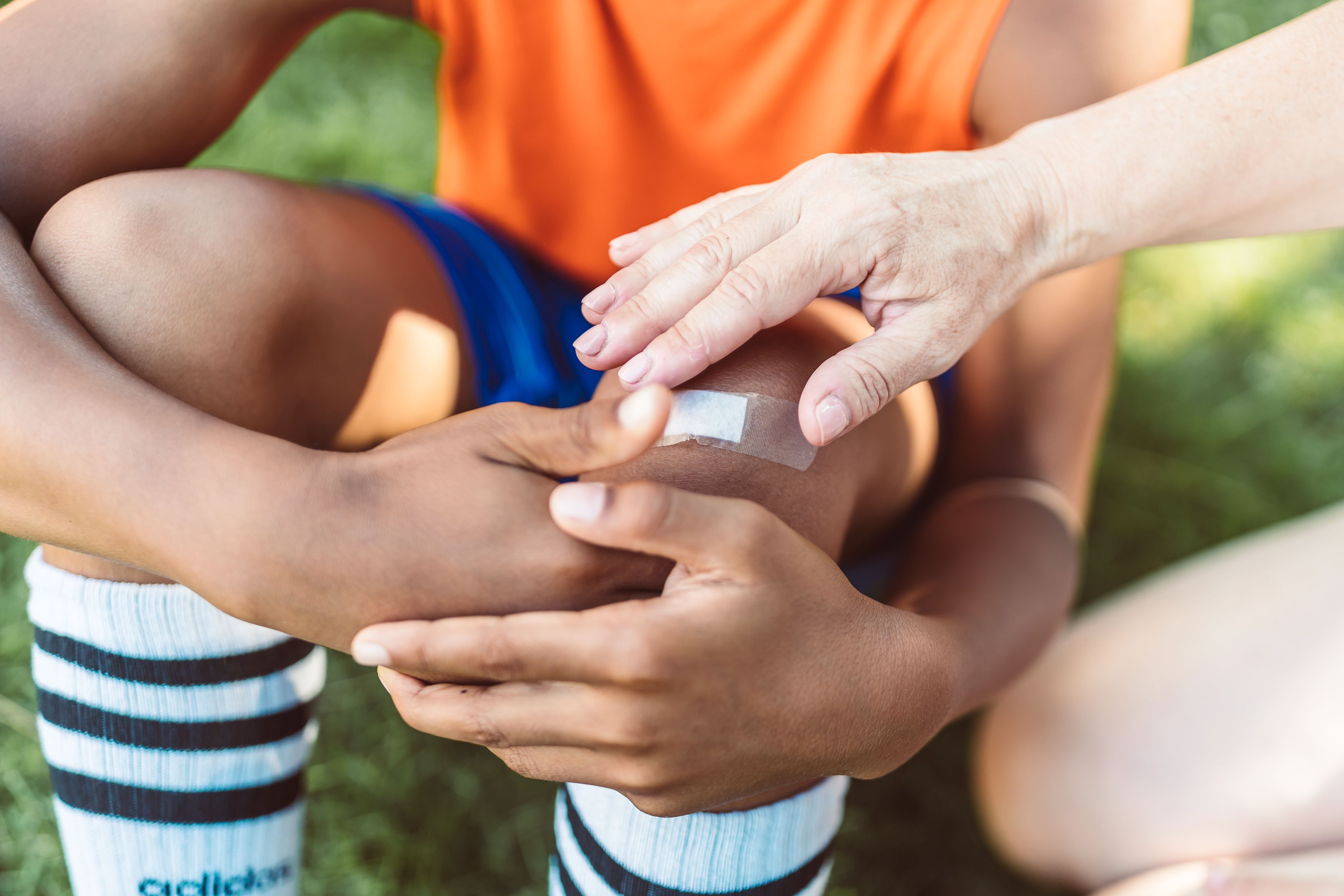 Guest receiving minor first aid for a scraped knee - guest medical coverage