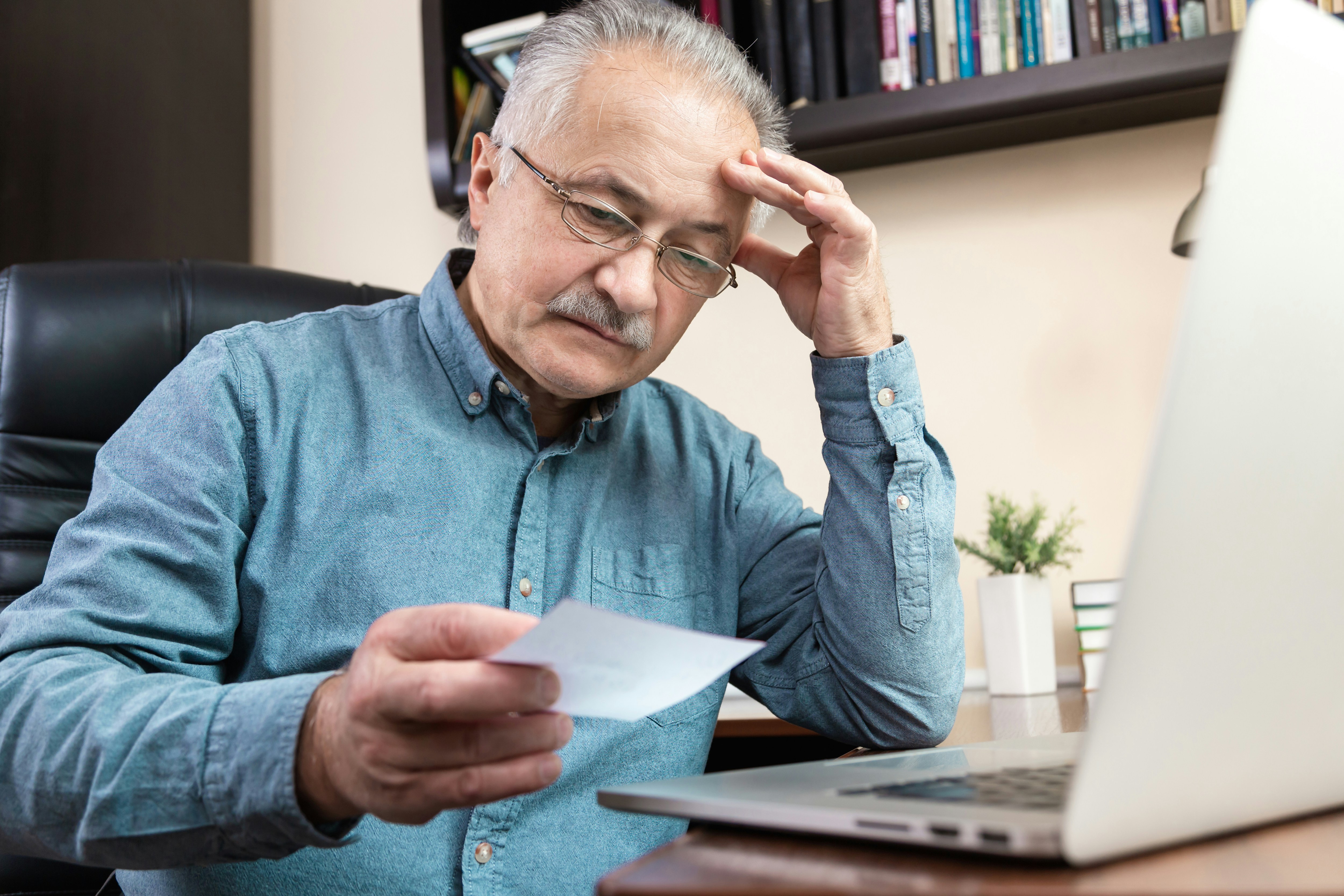small business owner reviewing insurance documents and costs - business equipment insurance small business owner reviewing insurance documents and costs - business equipment insurance