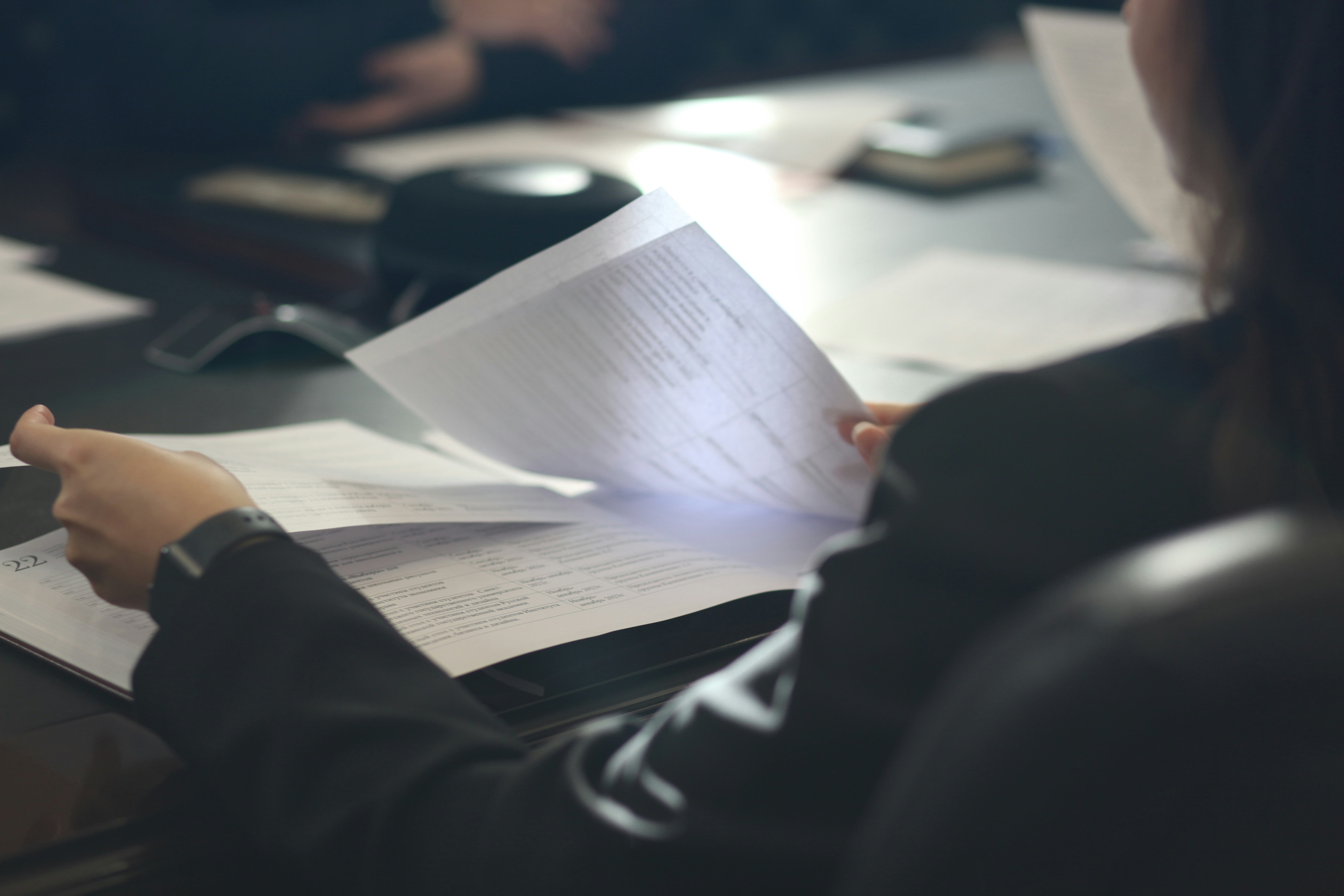 A person reviewing an insurance policy document carefully A person reviewing an insurance policy document carefully