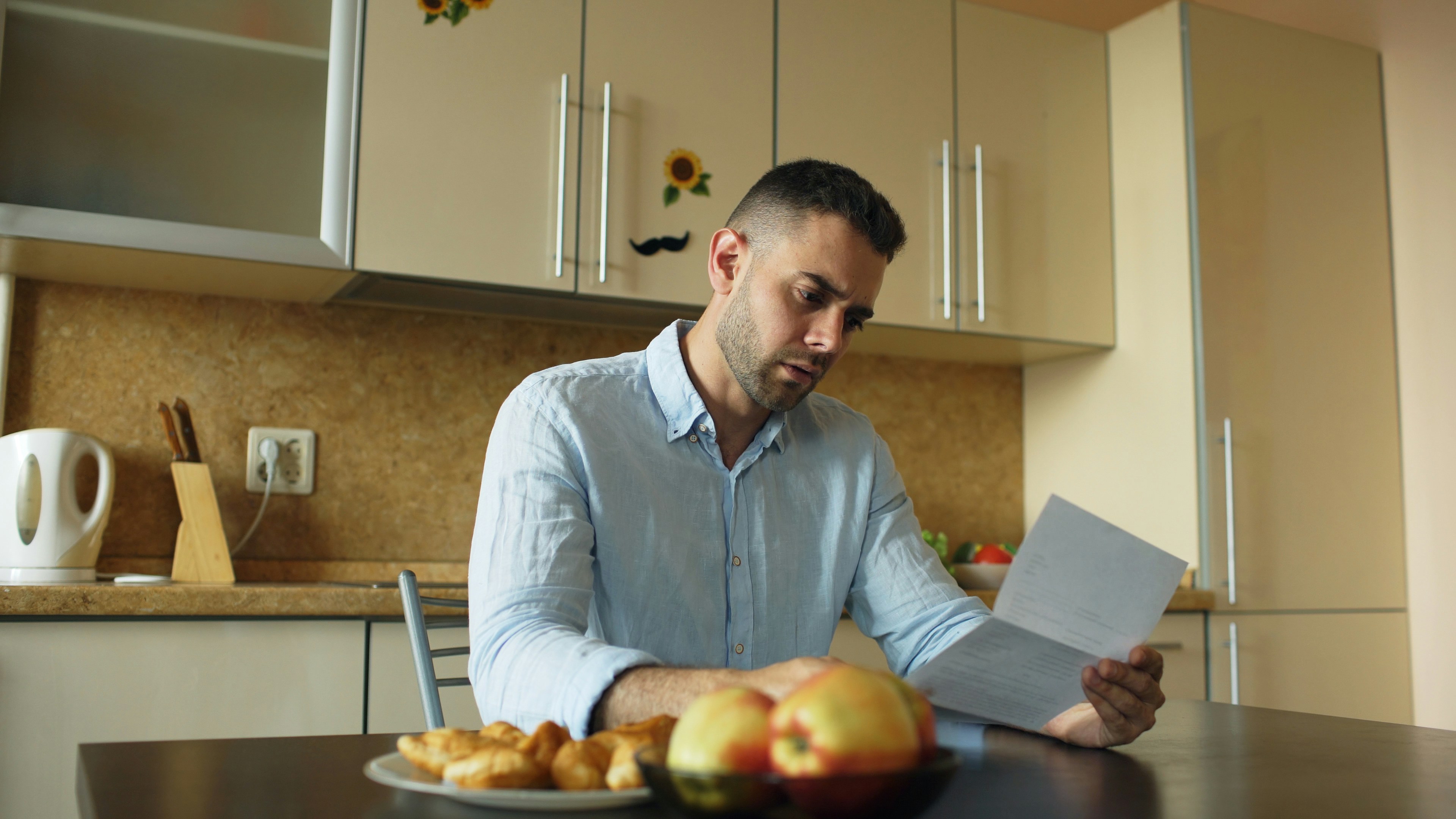 Homeowner reviewing financial documents and mortgage statements - life insurance for homeowners Homeowner reviewing financial documents and mortgage statements - life insurance for homeowners