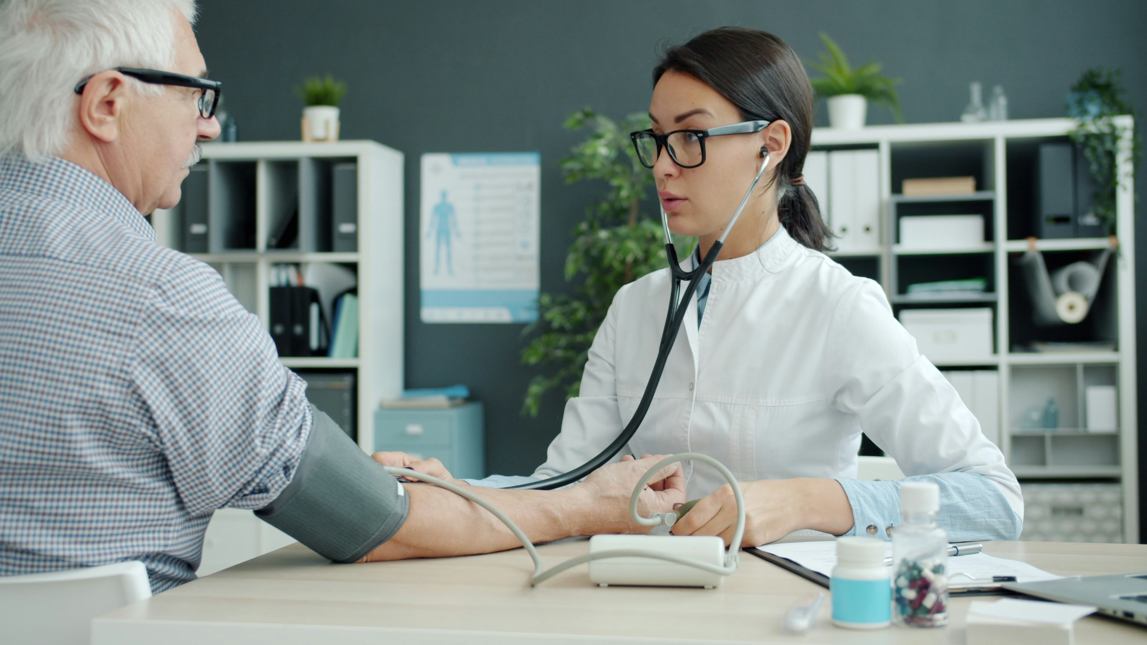medical professional conducting a health screening for life insurance - Life insurance premium