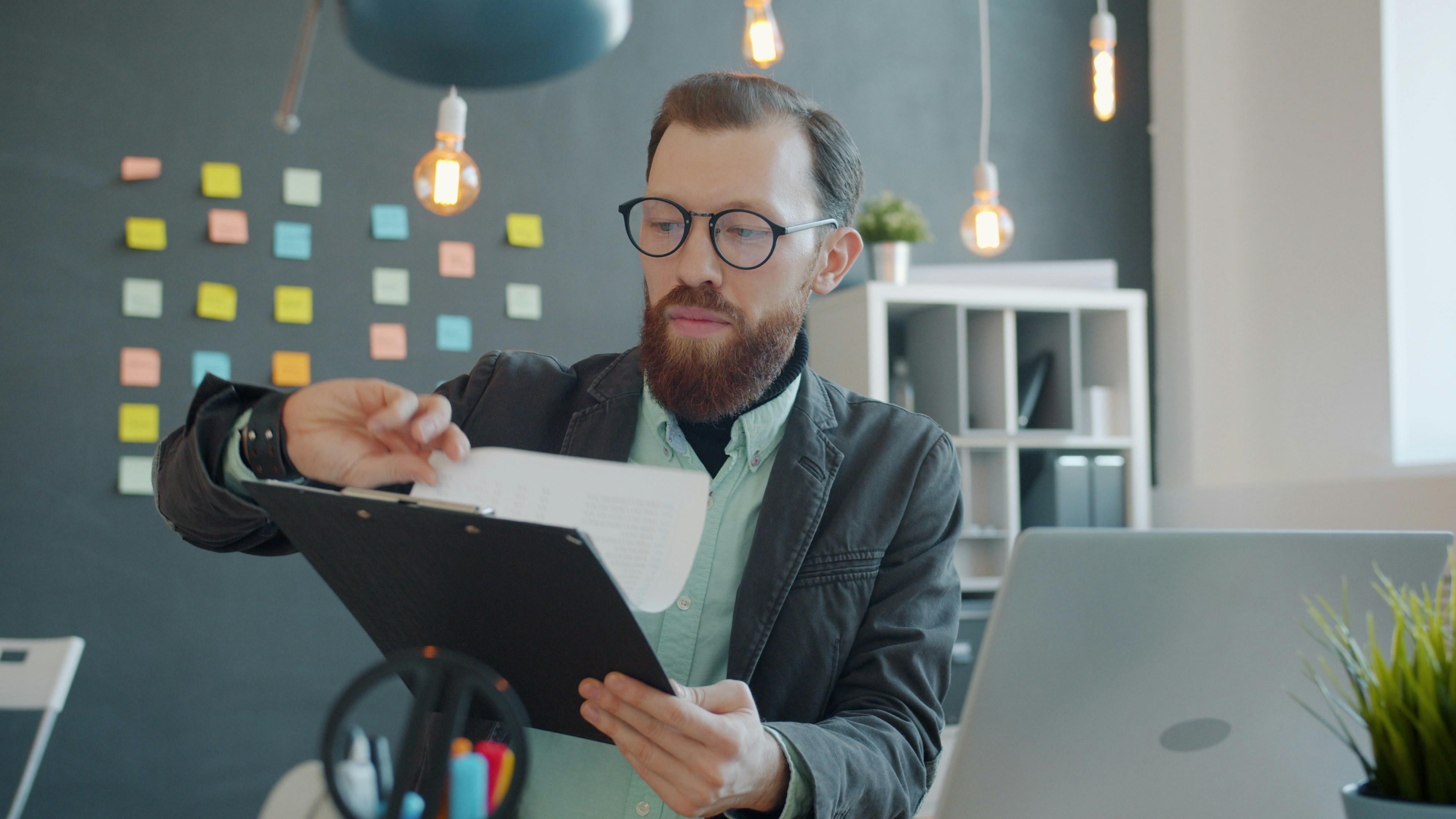 Business owner reviewing a risk assessment checklist - business insurance coverage